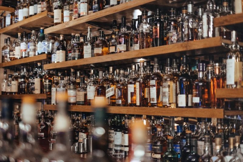 An assortment of liquor bottles on shelves