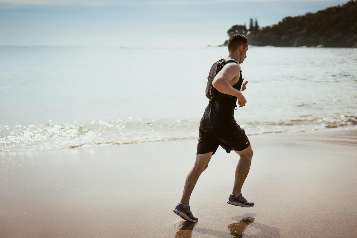 a wide shop of a man running on the beach